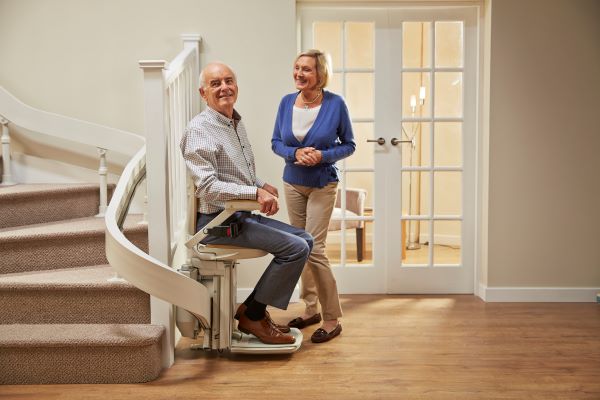 Happy couple after receiving their stairlift, surely after getting a free non-obligation quote and hearing acorn stairlifts price.